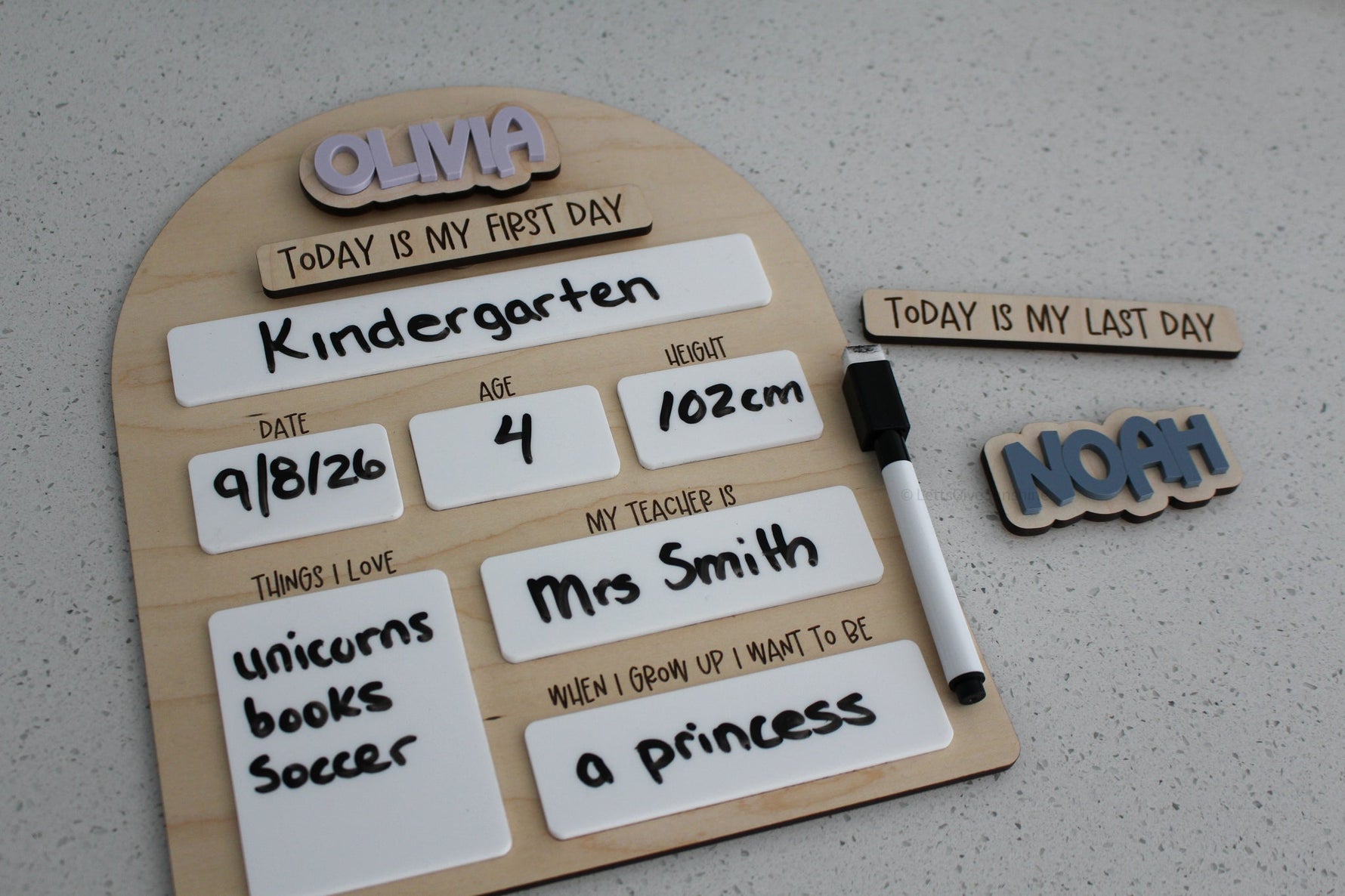 ersonalized wooden first and last day of school board with dry erase sections for grade, date, age, height, teacher, favourite things and future career, shown with interchangeable name and last day pieces.