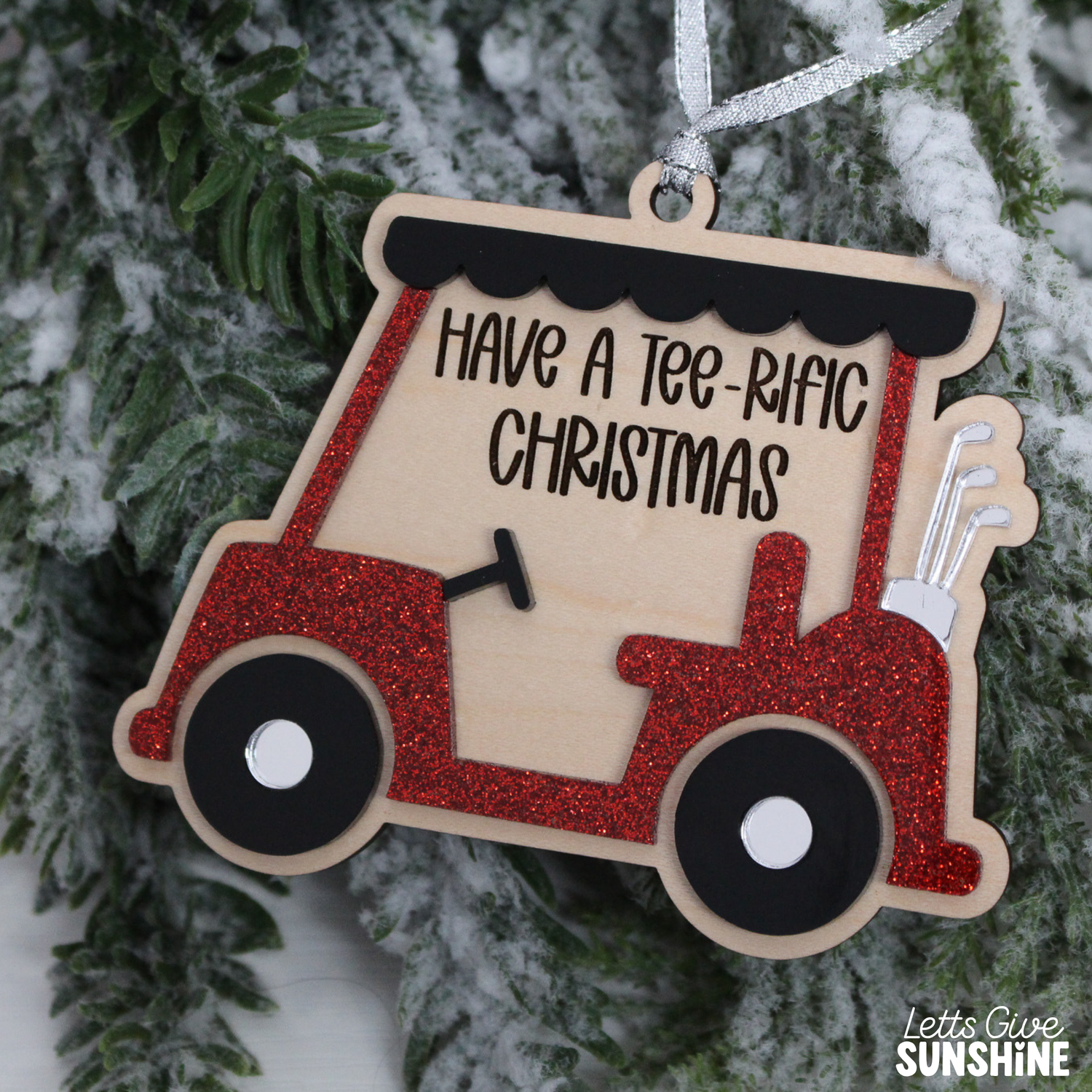 Layered wood and acrylic golf cart Christmas ornament with red glitter details, golf clubs, and the words Have a Tee-Rific Christmas.