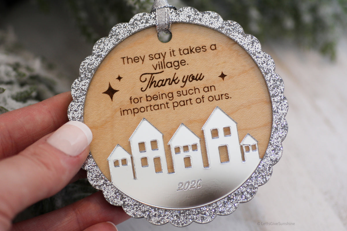 Handmade wooden thank you Christmas ornament for daycare providers and teachers, featuring an engraved It Takes a Village message and silver mirrored houses.