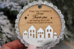 2026 It Takes a Village Christmas keepsake ornament with a scalloped silver glitter border, engraved appreciation message and layered silver acrylic village