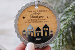 Close-up of It Takes a Village teacher and caregiver thank you ornament with reflective mirrored acrylic houses, natural wood and silver glitter edging