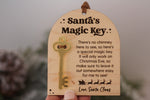 Santa's Magic Key for kids featuring an arched wooden plaque, attached gold key, engraved Christmas Eve poem and Love, Santa Claus signature
