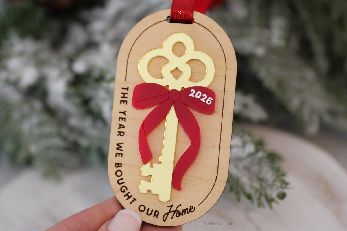 2026 new home Christmas ornament with gold mirrored acrylic house key, red bow and engraved The Year We Bought Our Home message