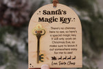 Close-up of a wooden Santa's Magic Key Christmas Eve ornament showing the gold acrylic key and message explaining how Santa enters without a chimney