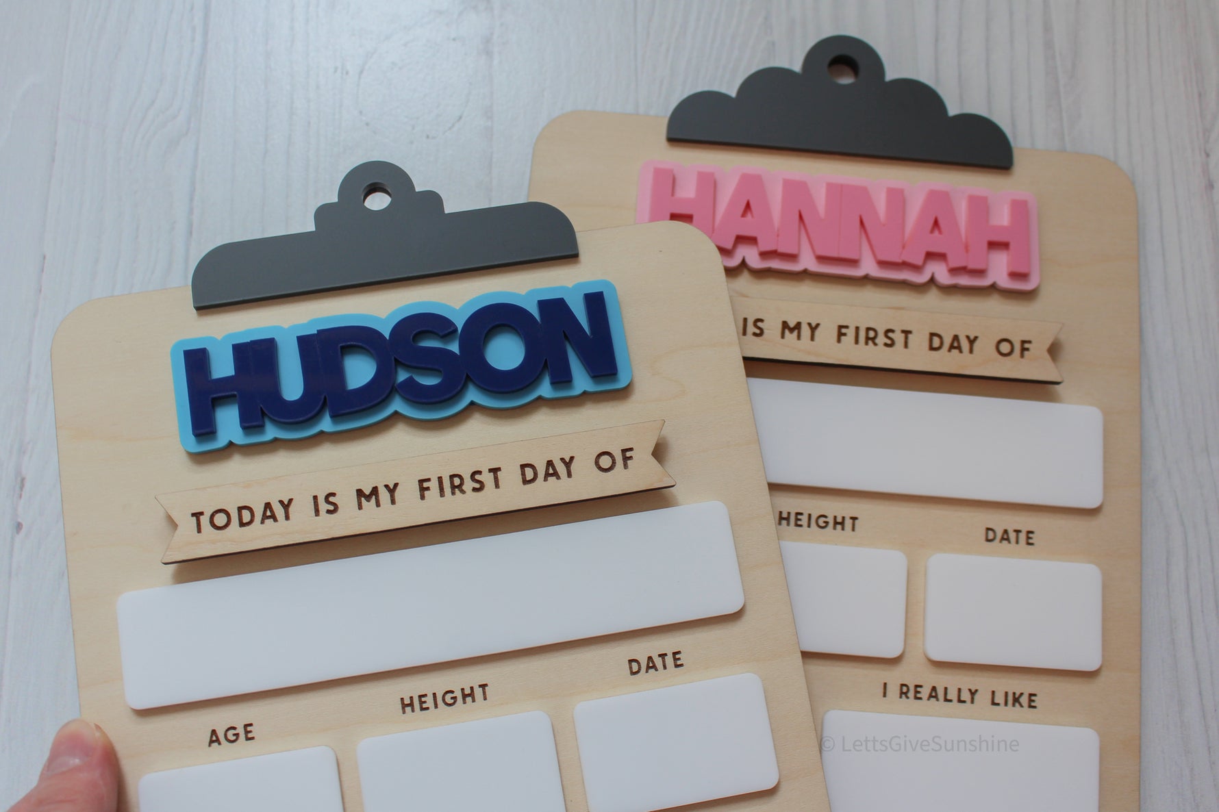 Reusable personalized back-to-school boards featuring the names Hudson and Hannah in blue and pink acrylic