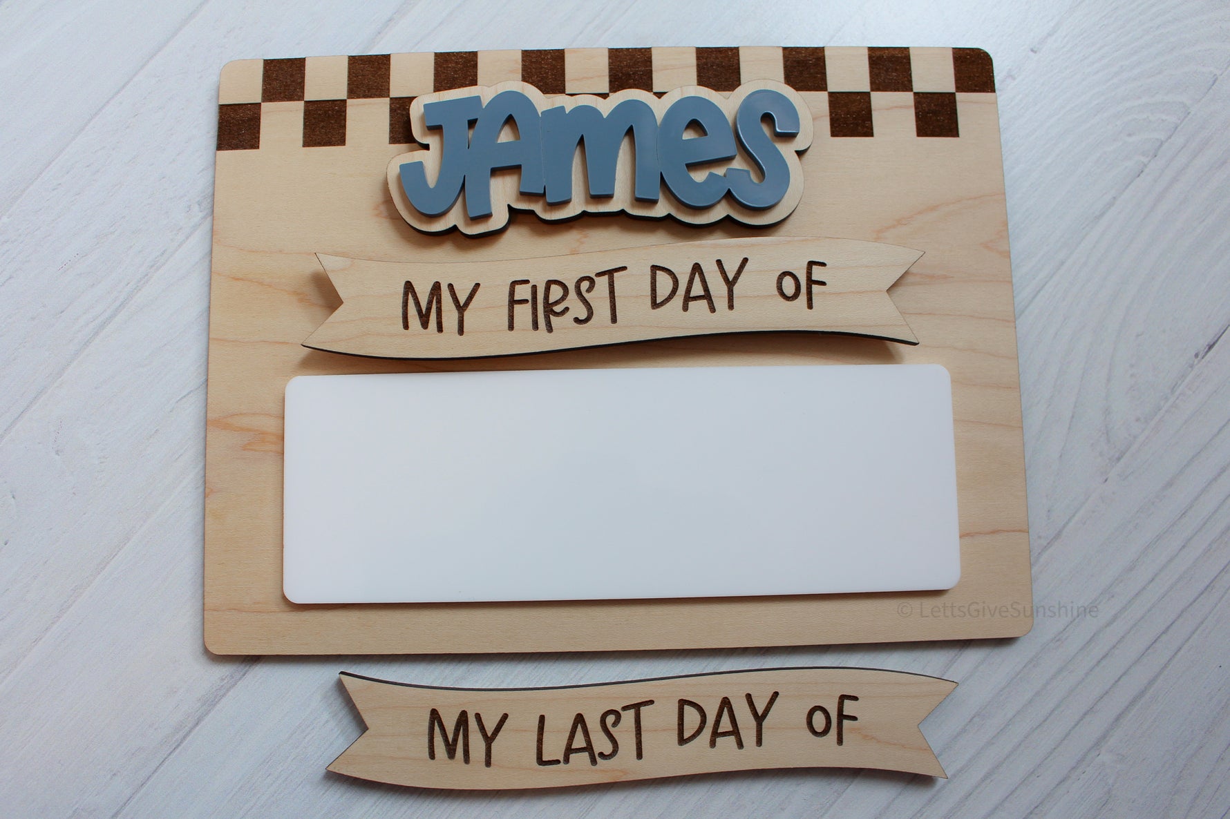 Personalized checkered first and last day of school dry erase board with blue name and interchangeable wooden banners.