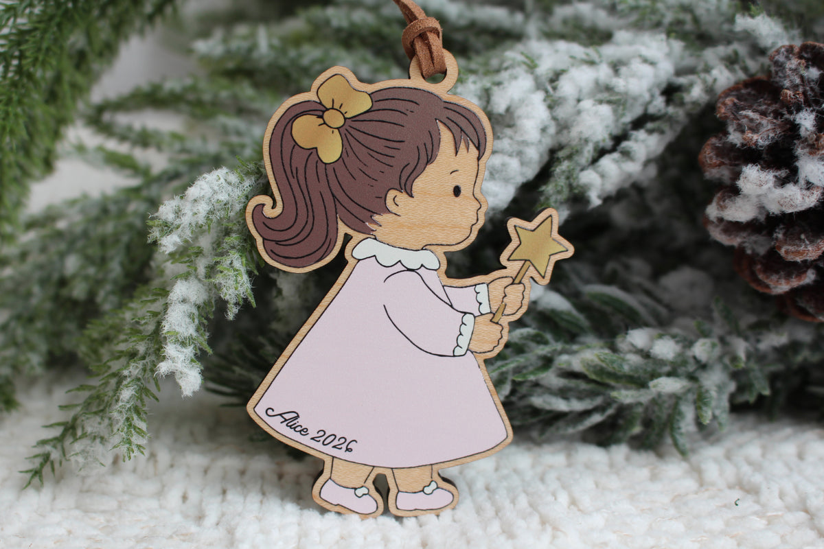 Personalized wooden Christmas ornament featuring a little girl in a pink dress holding a gold star wand, customized with the name Alice and year 2026