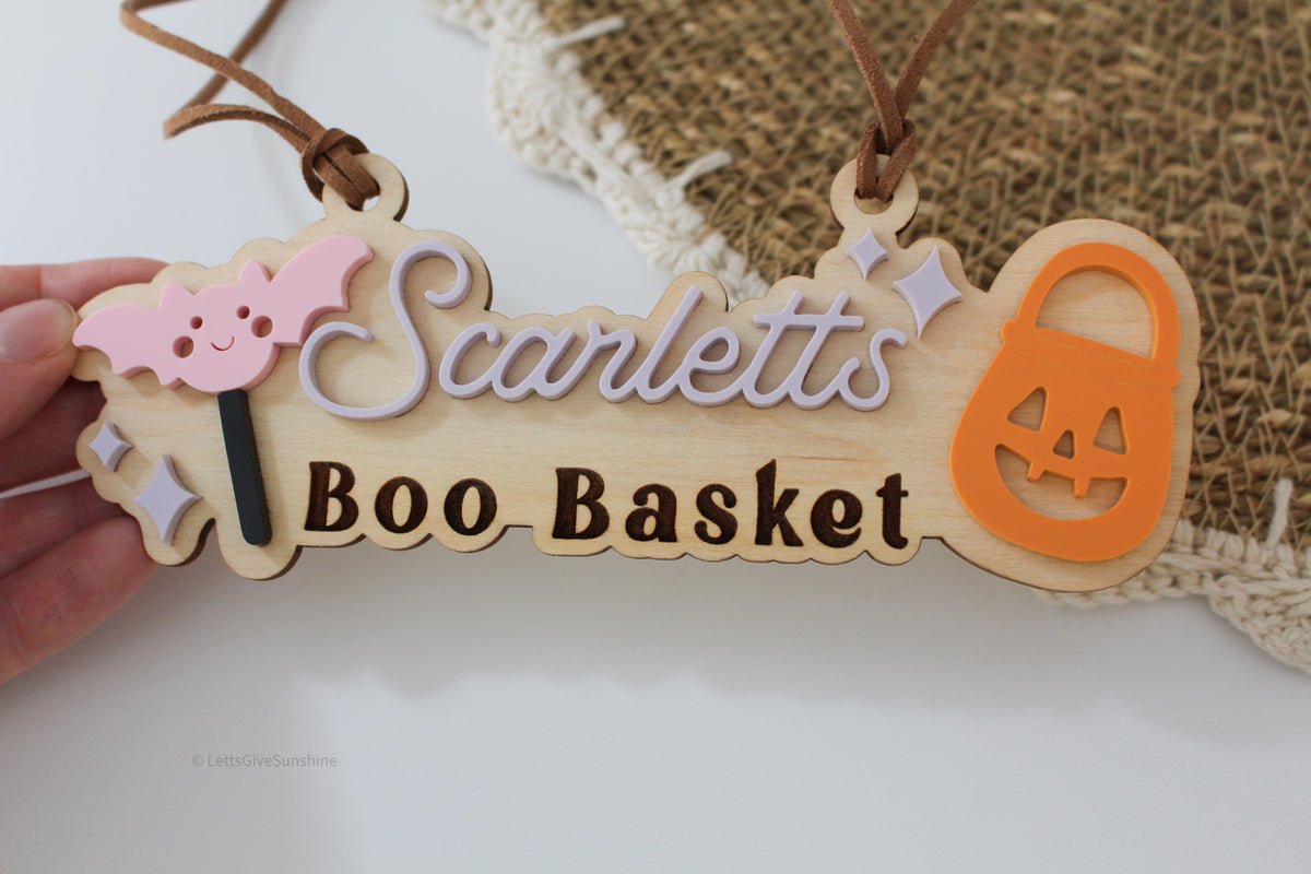 Personalized wooden Boo Basket tag with child’s name, pink bat, orange pumpkin bucket and Halloween accents