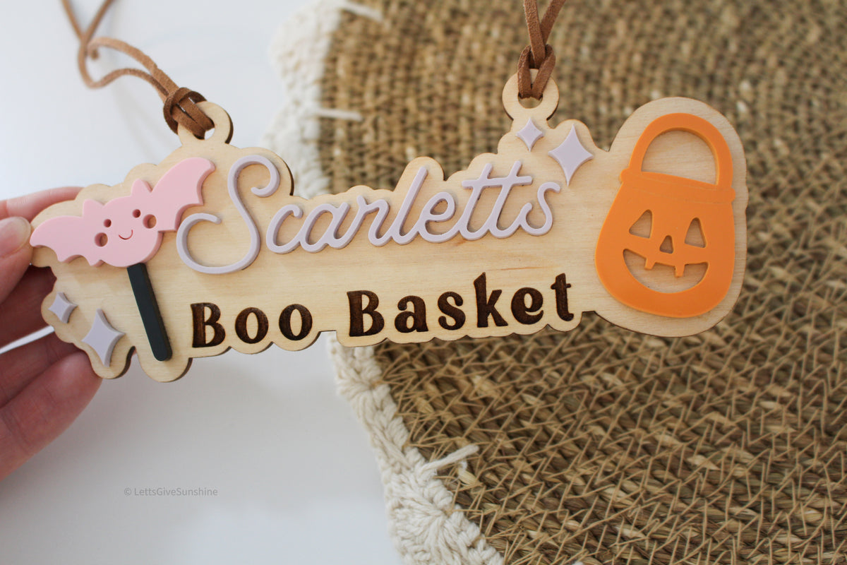 Personalized wooden Boo Basket tag with child’s name, pink bat, orange pumpkin bucket and Halloween accents