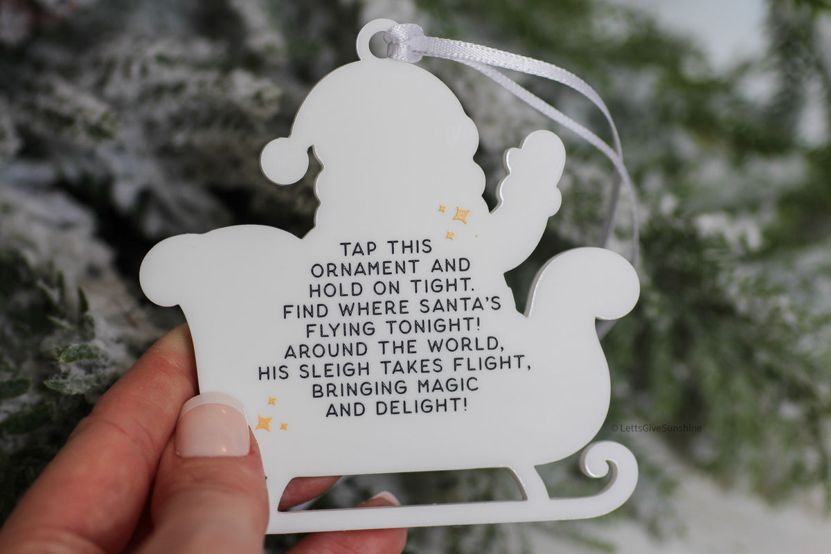 Back of interactive Santa Tracker ornament featuring instructions to tap with an NFC smartphone and follow Santa's journey on Christmas Eve.