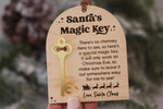 Santa's Magic Key Christmas tradition plaque with attached gold key, decorative stars, Santa's sleigh and reindeer, and engraved holiday message