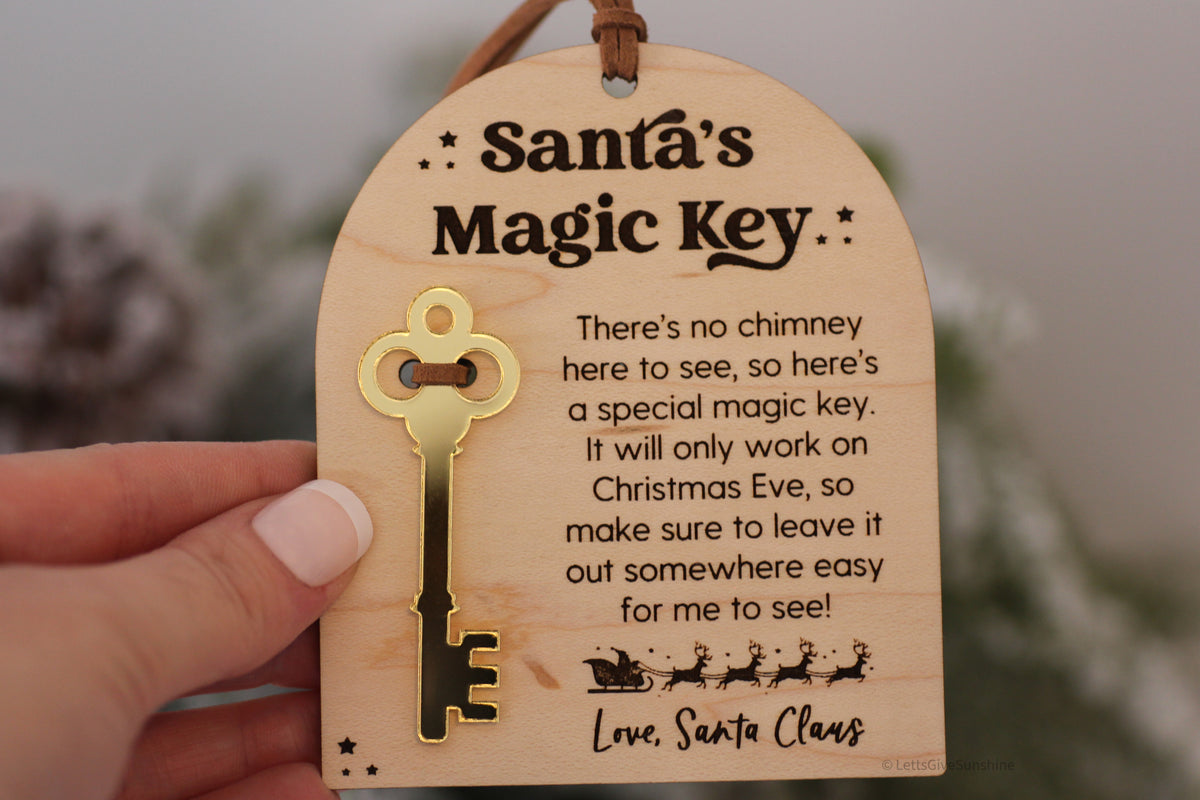 Wooden Santa's Magic Key ornament for homes without a chimney, featuring a gold mirrored key and engraved Christmas Eve instructions from Santa Claus.