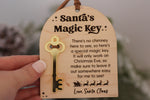 Wooden Santa's Magic Key ornament for homes without a chimney, featuring a gold mirrored key and engraved Christmas Eve instructions from Santa Claus.
