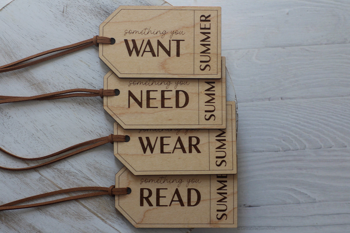 Set of four wooden Christmas gift tags engraved with Something You Want, Need, Wear and Read, personalized with Summer and finished with brown cords.