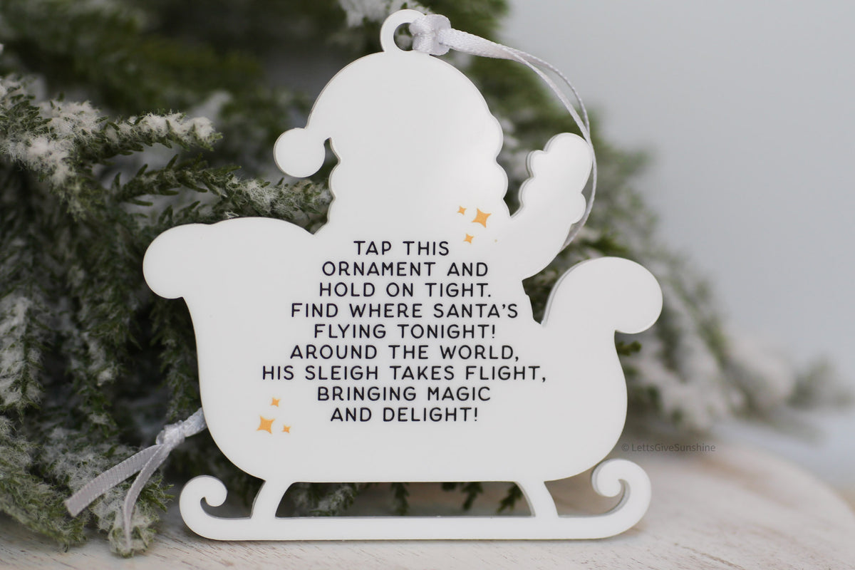 Back of interactive Santa Tracker ornament featuring instructions to tap with an NFC smartphone and follow Santa's journey on Christmas Eve.