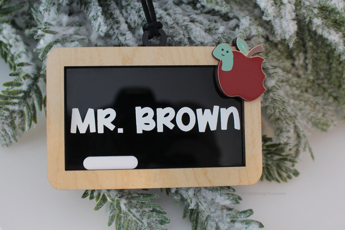 Personalized classroom chalkboard Christmas ornament for teachers featuring a natural wood frame, custom white name lettering and black hanging cord