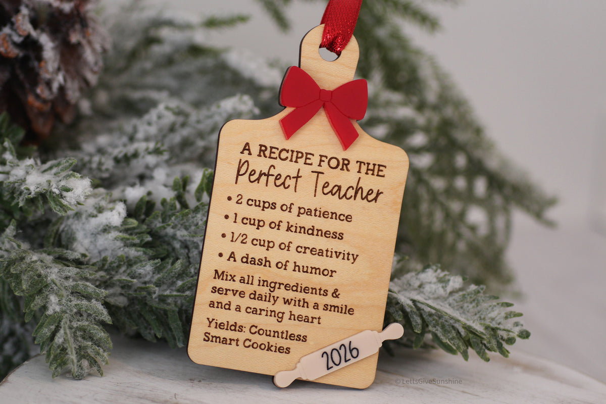 Teacher gift ornament made from wood with engraved recipe wording, layered red bow, and festive Christmas hanging ribbon.