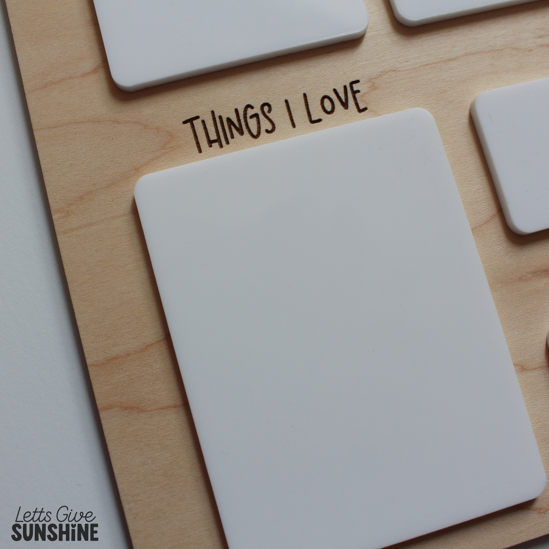 Close-up of the white dry erase “Things I Love” section on a personalized wooden first day of school milestone board, designed to be filled in and reused each year.
