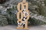 Personalized wedding date Christmas ornament featuring wooden numbers with a layered white Smith last name, a custom keepsake for newlyweds and anniversaries.
